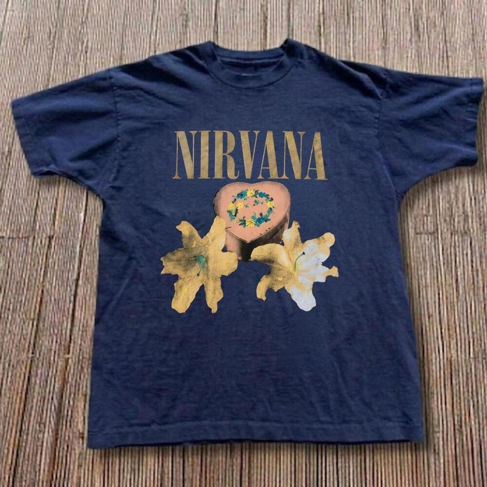 Nirvana Band Tee With Gold Text And Graphic Of A Heart With Flowers And Lilies